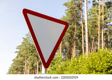 A Road Sign Indicating The Obligation To Give Way , A Road With Established Road Signs