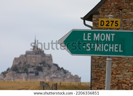 road sign with the inscription Mont Saint Michel and the arrow indicating the ancient abbey