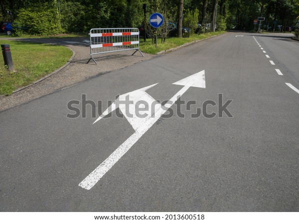 Road sign, lane markings - Straight ahead and\
turn to the left closed by a\
fence