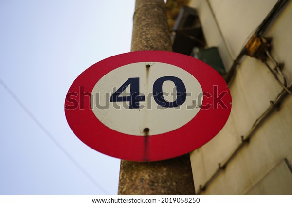 A road sign mounted on a post indicating a 40\
mph speed limit for vehicles