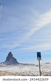 road sign near Agathla Peak also called El Capitan at Highway 163 (Monument Valley Scenic Road) in Arizona near Kayenta on a sunny day in January