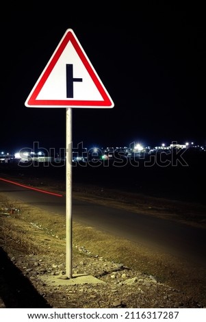 Road sign at night. Night scene with a traic signpost.