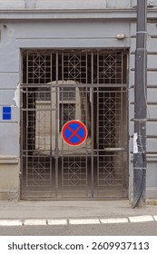 Road Sign No Parking at Metal Gate Entrance Door