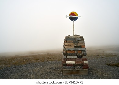 A road sign at Nordkapp, Norway under a foggy sky