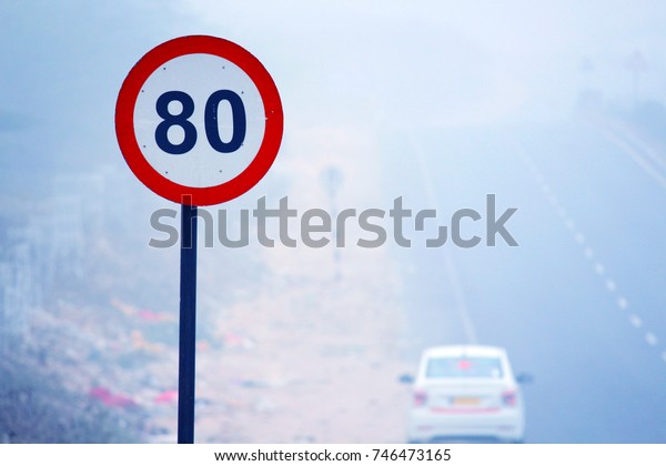 Road sign on foggy\
day
