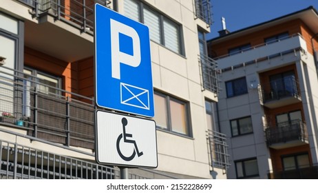 Road sign on parking site with warning about place for disabled people. Parking place for cars of people with disability