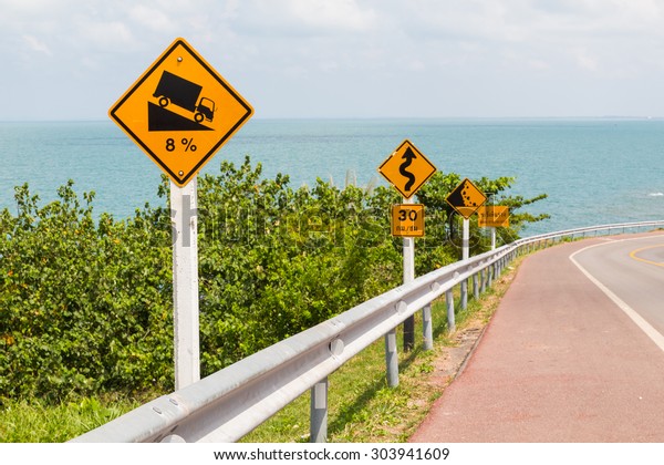road sign\
on the sea road with blue sky in\
Thailand