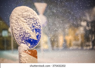 Road Sign On The Street After Snowstorm, Winter And Night Photography, Snow Calamity