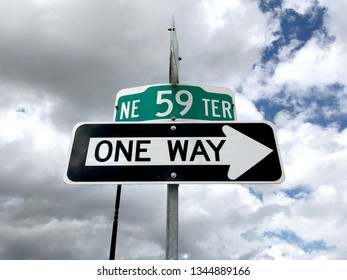 Road Sign One Way With Cloudy Sky On Parking Spot