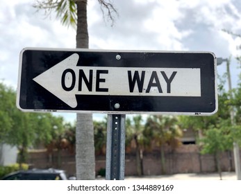 Road Sign One Way With Cloudy Sky On Parking Spot