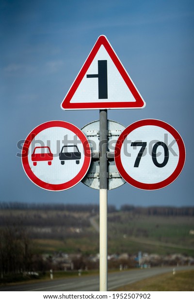road sign overtaking is
prohibited. road sign speed limit 70 km h. road sign turn right
close up