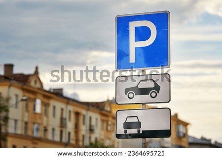 Road sign - Parking sign in the city. Parking zone for cars. Parking sign, city on background