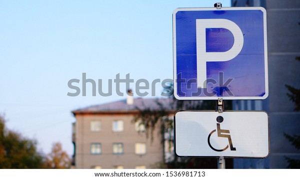 Road sign Parking for persons with disabilities\
on the post closeup