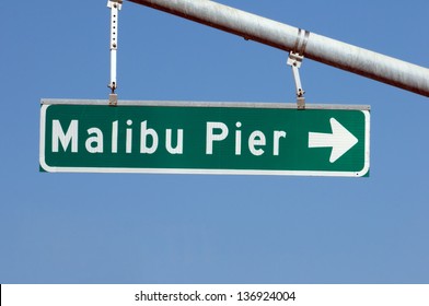 Road Sign Pointing To Malibu Pier In California