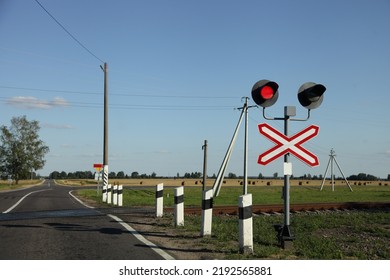 Road sign with railway red traffic light on countryside empty one way railroad crossing at Sunny summer day