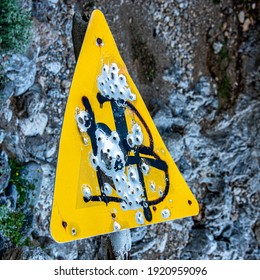 Road Sign Riddled With Bullet Holes 