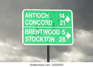 Road Sign With Several Bullet Holes