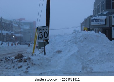 Road sign and snow dump
In Iqaluit, Nunavut, Canada
on a cloudy day