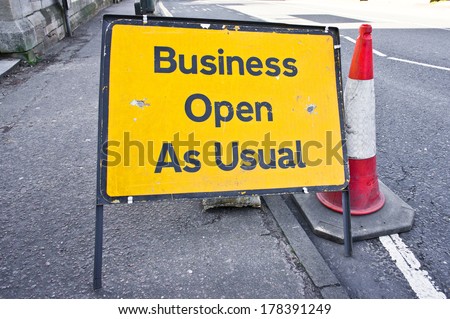 Road sign stating business open as usual during period of road works