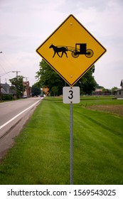 A Road Sign That Shows An Amish Horse And Buggy Crossing