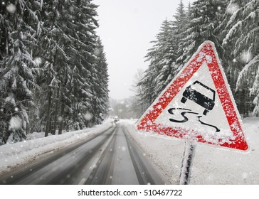 Road Sign Warning Against Slippery Road Due To Snow Ice