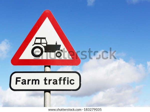 Road sign\
warning of farm traffic on the road\
ahead.