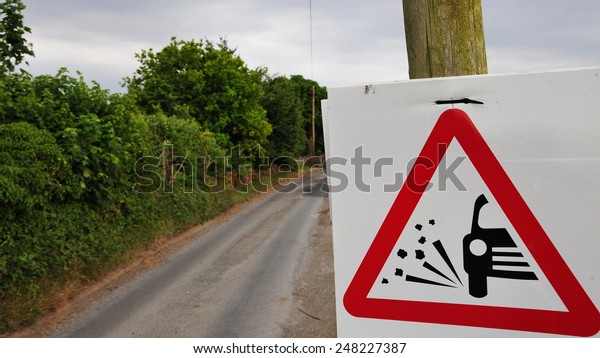Road Sign\
Warning of Loose Gravel on a Country\
Road