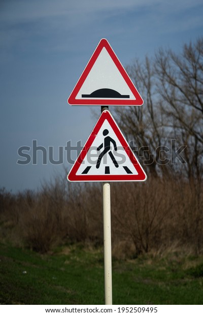 road sign warning pedestrian crossing.\
road sign for roughness on the road. raw\
footage
