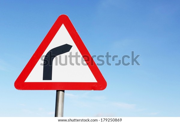 Road sign warning of\
a sharp bend ahead.