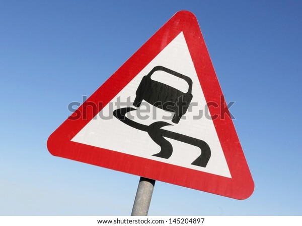 Road sign warning of\
slippery conditions.
