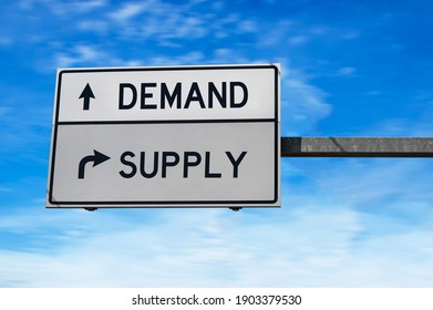 Road sign with words demand and supply. White two street signs with arrow on metal pole. Directional road, Crossroads Road Sign, Two Arrows on blue sky background