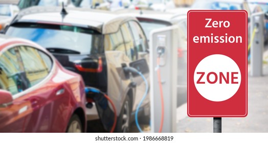 Road sign "Zero emission ZONE" on a background of electric cars. Clean mobility concept