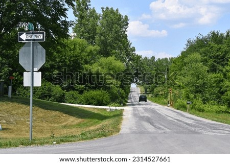 Road signs by a blacktop road