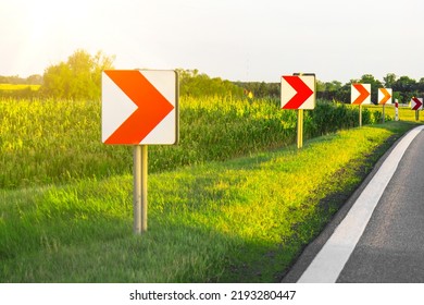 Road Signs In European Style Warn Of A Sharp Turn On A Narrow Road, A Sharp Turn