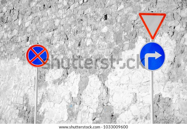 Road signs on a stone\
wall background