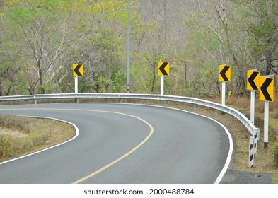  Road Signs Warn Of A Sharp Turn On A Narrow Road. 