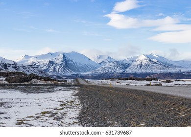 Road With Snow Mountain, Cloud, And Blue Sky In Spring Season In Iceland