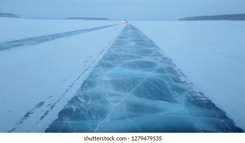 Road To A Snowstorm On The Cracked Ice Of The River.Frozen River Ice Of  Lena River In Yakutia In Winter. Way Truckers  Along The Frozen River, Dangerous Route Of Siberia; North Of Russia; Lena Pillar