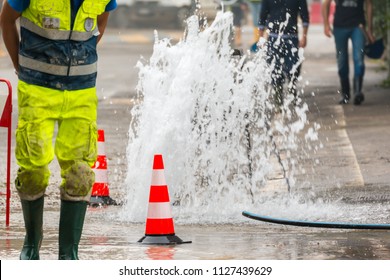 road spurt water beside traffic cones