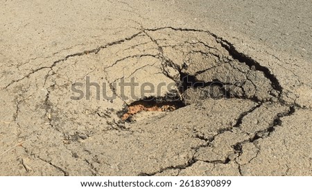 Road surface damaged by ground subsidence