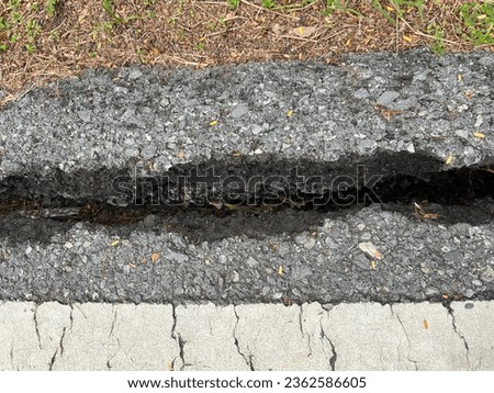 The road surface has cracks. It is caused by excessive road weight in that area, digging, drilling, hammering or deterioration in most applications. or from factors in low quality construction