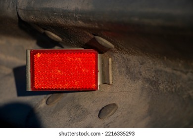 A  Road Surface Reflector With Red Colour.