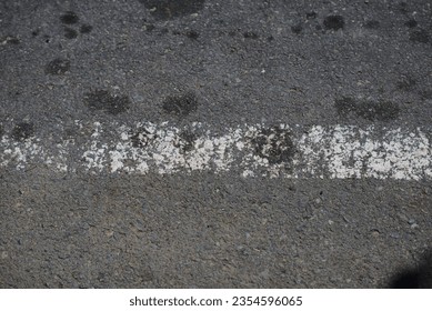 road surface texture made of asphalt with faded paint - Shutterstock ID 2354596065
