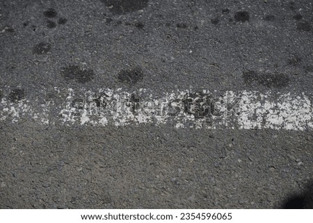 road surface texture made of asphalt with faded paint