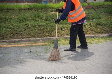 Road sweeper worker cleaning city street with broom tool in Thailand