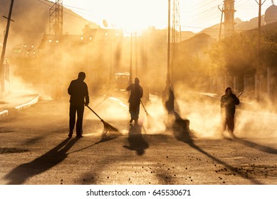 Road sweeper worker cleaning leh city market street with broom tool in early morning