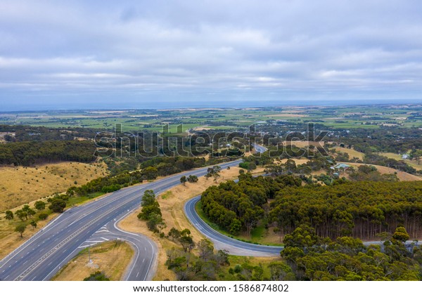 A road system running through large green\
farmland south of Adelaide in\
Australia