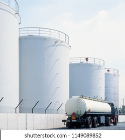 Road Tanker In Front Of Oil Refinery Tanks, Neutral With Copy Space