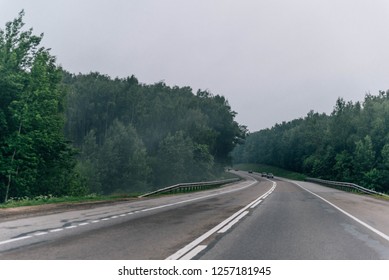 road through clouds forest