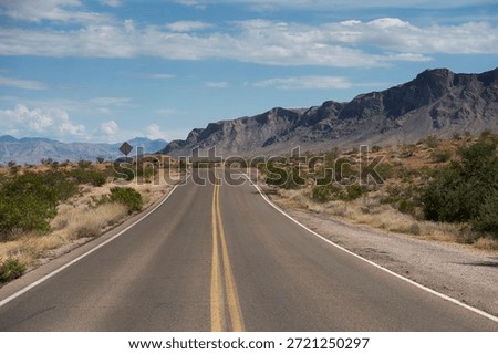 A road through the dramatic landscape and sandstone formations within the valley of fire state park in Moapa Valley, Nevada.
